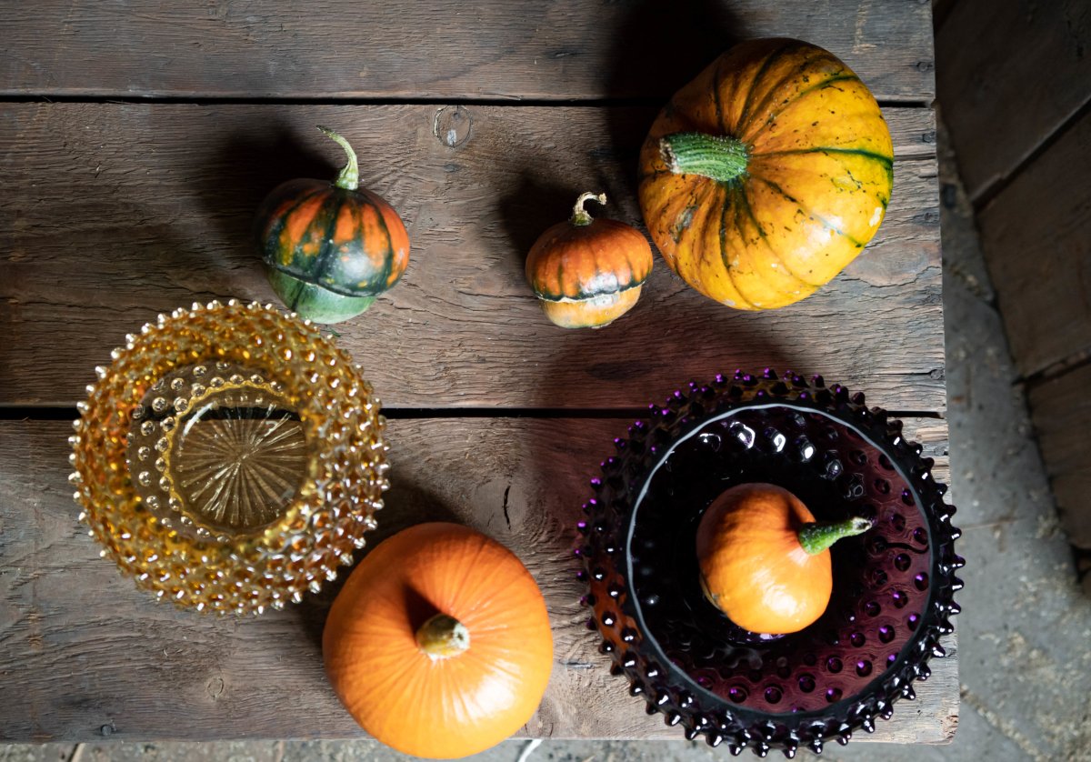 Violet Hobnail Bowl on a wooden table surrounded by pumpkins