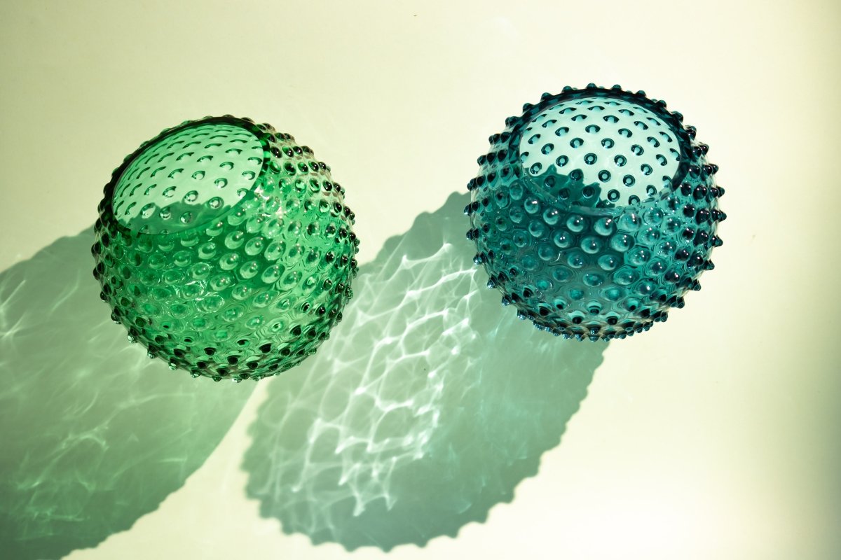 Underlay Dark Green Hobnail Vase on a white table  