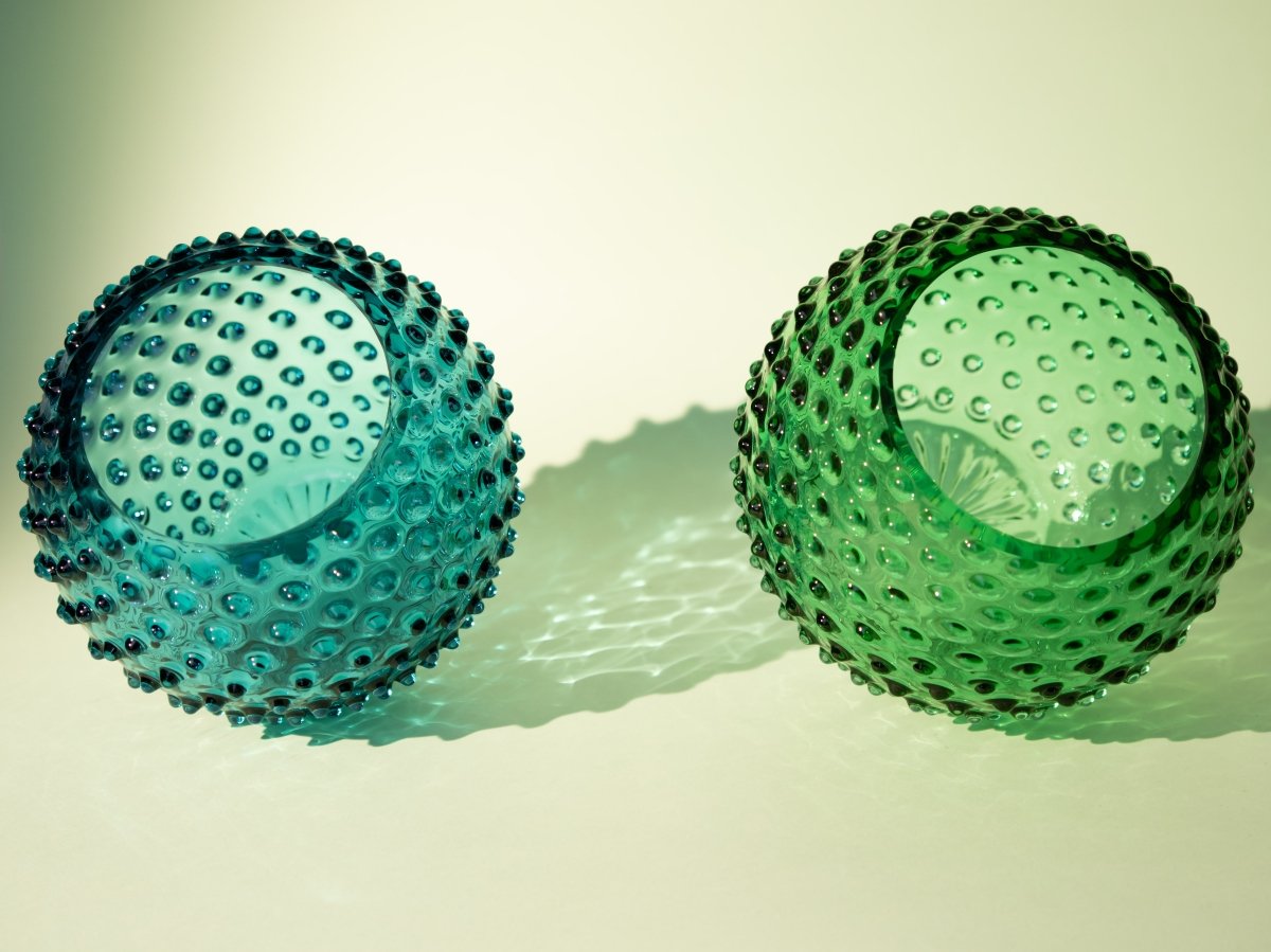 Underlay Dark Green Hobnail Vase on a white table 