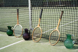 Underlay Dark Green Hobnail Jug on a tennis court with rackets and a net 
