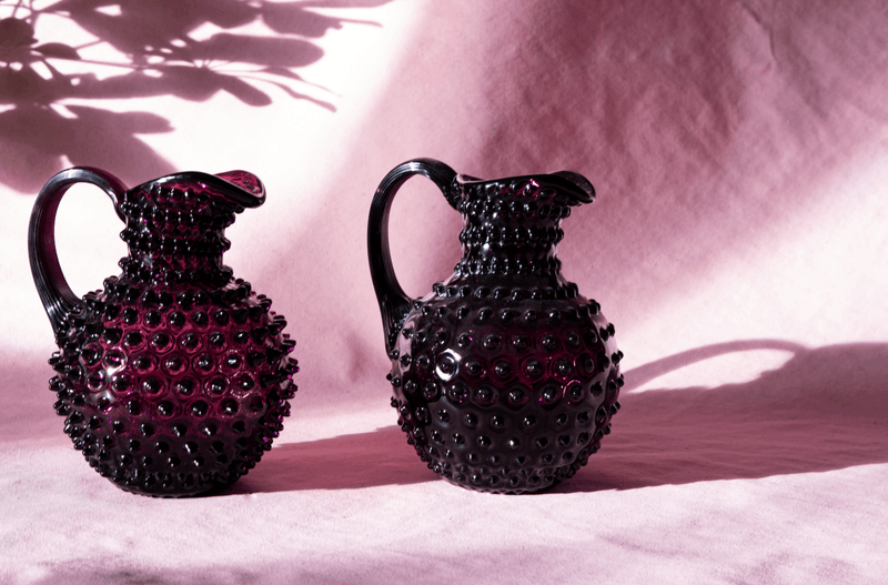 Violet Hobnail Jug on a pink fabric with shadows in the background 